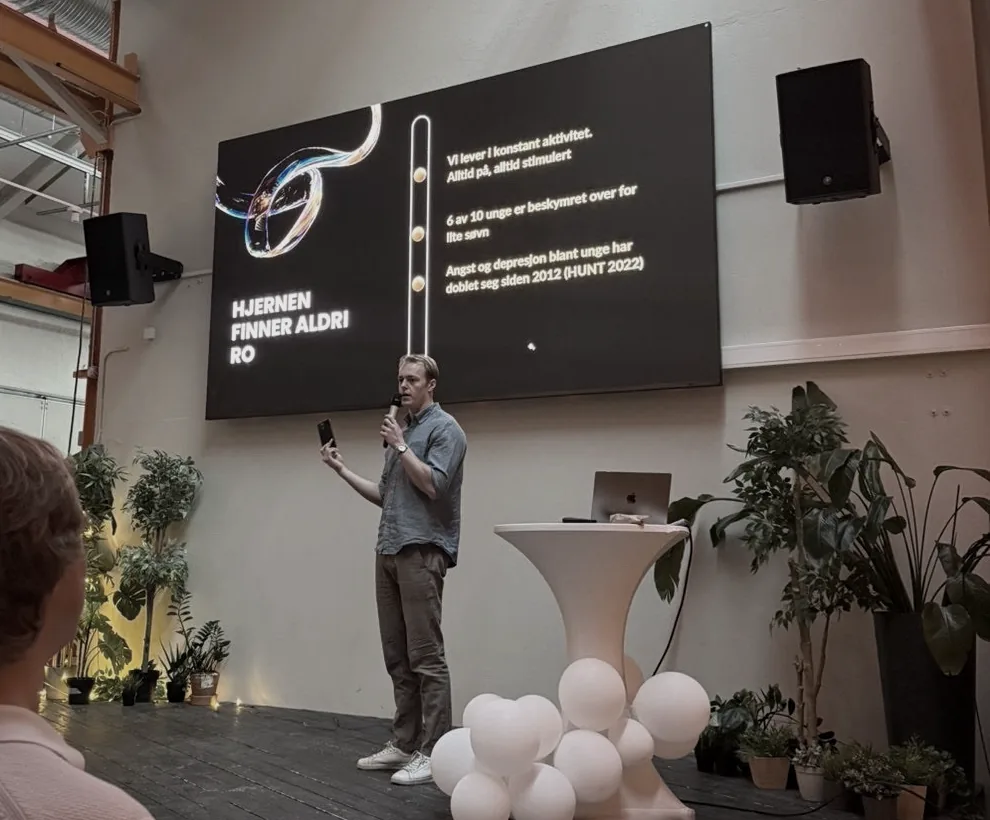 A co-founder presenting ThetaMask on stage in front of a slide carrying the mark.